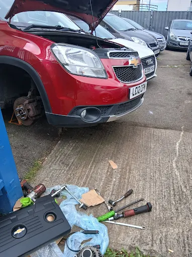 Mechanic pouring oil into an engine