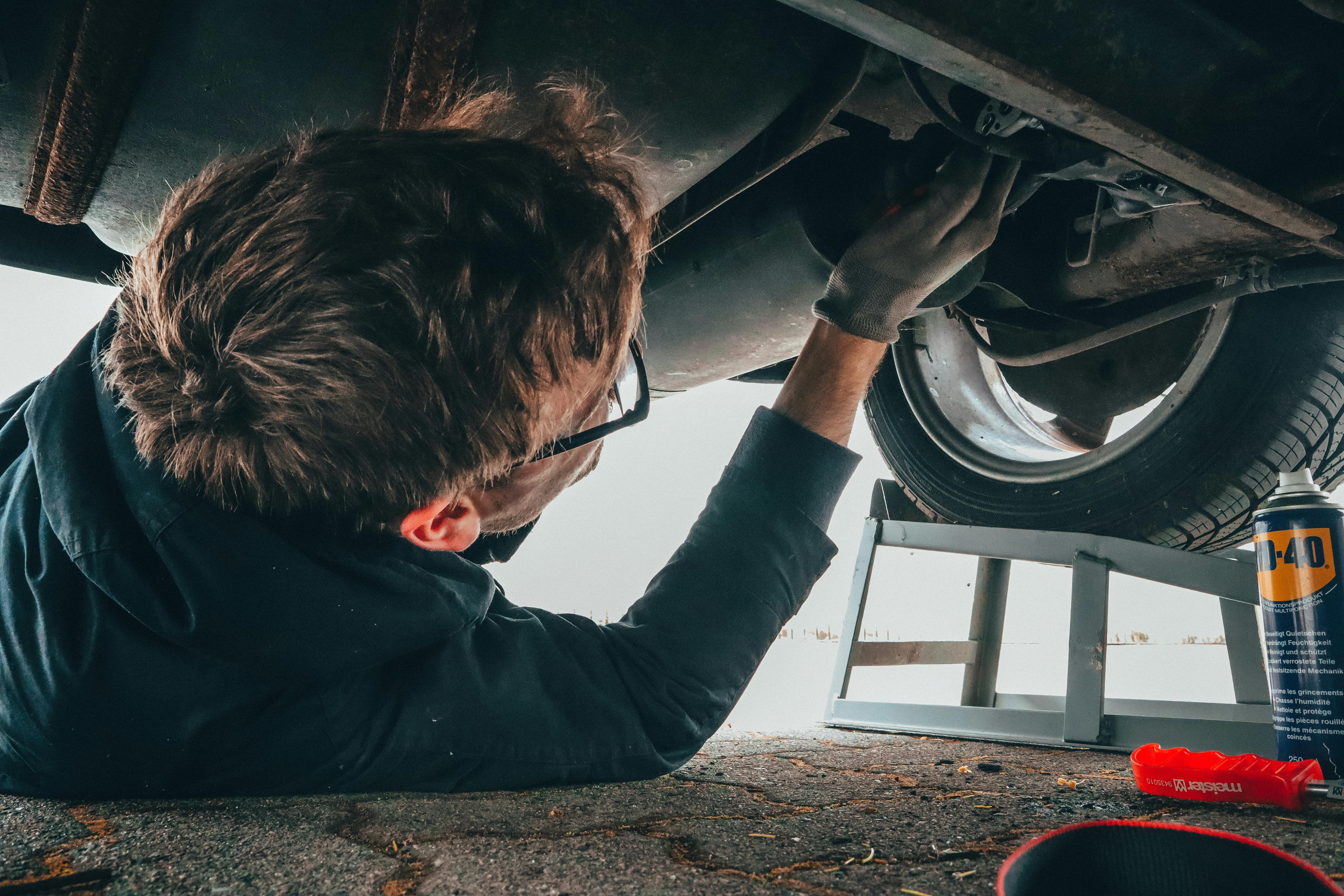 Mechanic at work on car engine