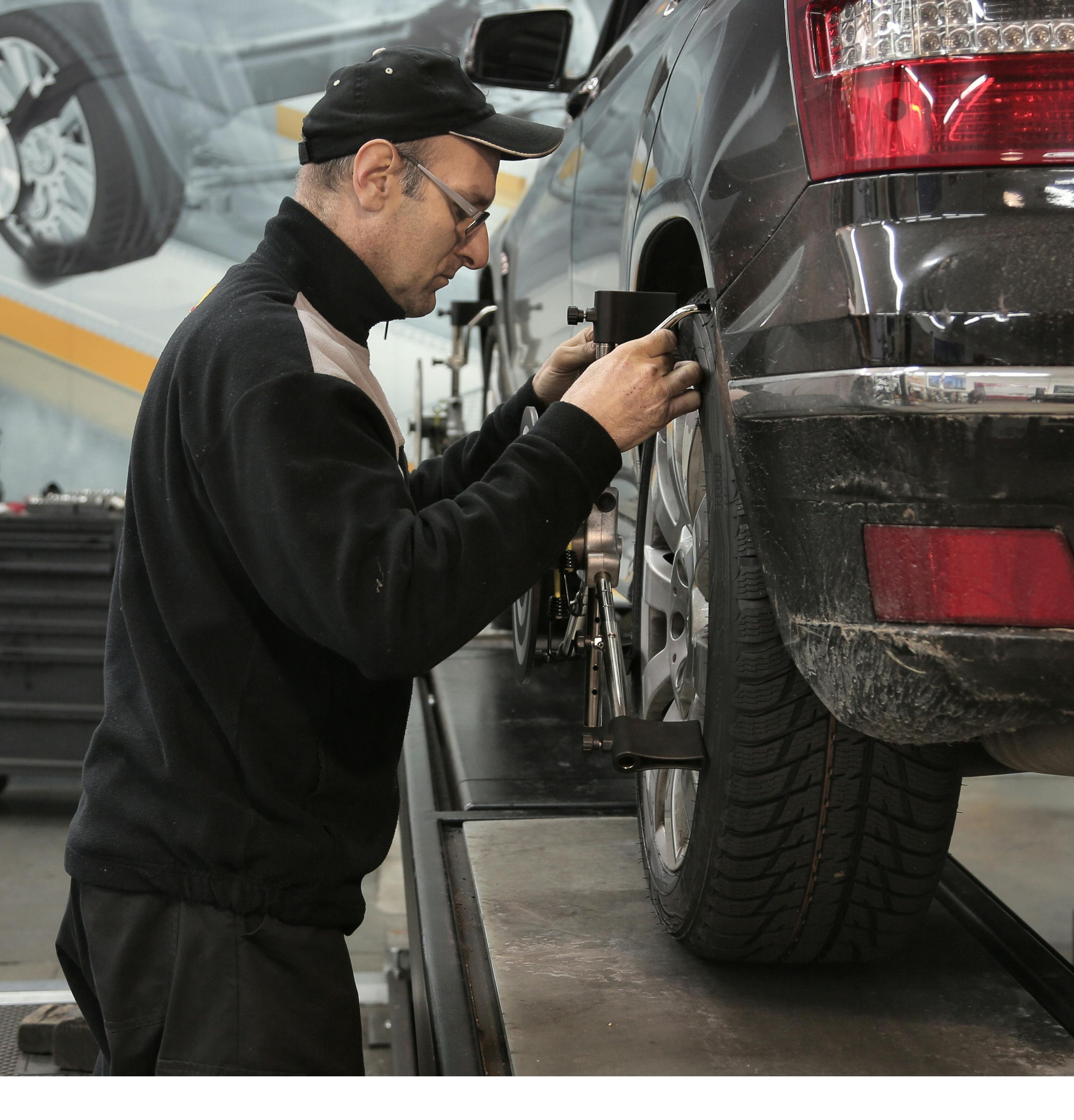 Mechanic pouring oil into an engine